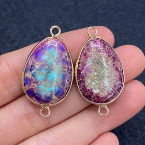 Natural purple and red emperor stone teardrop pendants with gold metal edging and dual loops