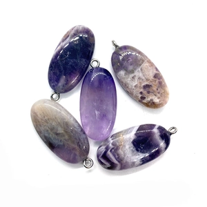 Detailed macro view of five natural amethyst teardrop pendants with silver ring connectors