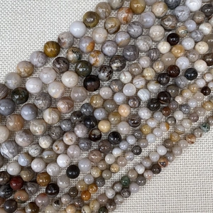 Macro detail of polished earth-tone natural stone round beads for DIY jewelry making