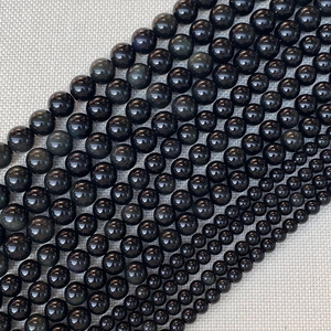 Makroaufnahme von Regenbogen-Obsidian-Rundperlen in verschiedenen Größen von 4mm bis 14mm