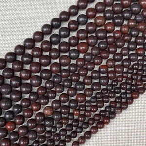 Detailed view of polished red jasper stone beads in sizes from 4mm to 12mm for jewelry