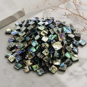 Detailed macro view of square natural abalone shell beads showing iridescent colorful luster