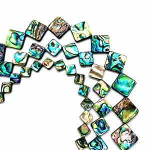 Macro detail of square abalone shell beads with natural iridescent luster and blue green hues