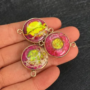Close-up of three circular marble textured connectors with gold plating for jewelry making
