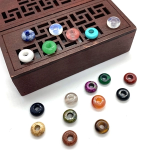 Close-up of colorful 4x10mm natural stone abacus beads on a decorative wooden box