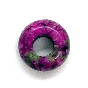 Macro detail of polished purple and green natural stone abacus bead for jewelry making