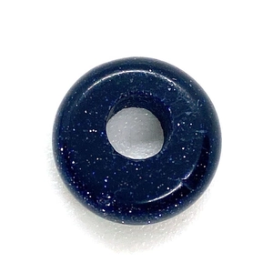Macro shot of dark blue goldstone abacus bead with shimmering starry texture for DIY jewelry