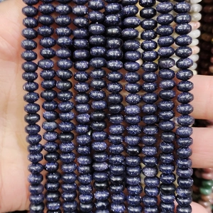 Macro shot of blue sandstone rondelle spacer beads with natural sparkling star effect