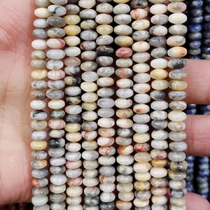 Detailed close-up of 4x6mm striped agate and goldstone wheel beads for DIY jewelry making