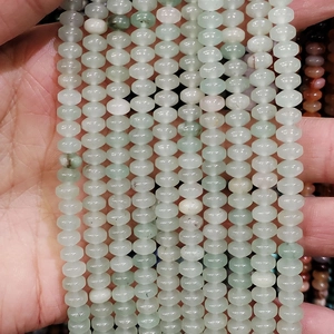 Macro shot of 4x6mm light green wheel-shaped natural agate stone beads for DIY jewelry
