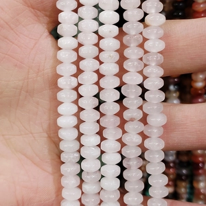 Macro shot of 4x6mm pink rose quartz rondelle beads for DIY jewelry making necklaces