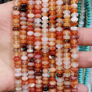Macro shot of 4x6mm striped agate abacus beads showing natural texture and warm tones
