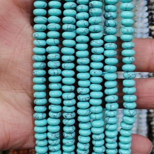 Macro shot of turquoise rondelle beads with black marble patterns for DIY jewelry making
