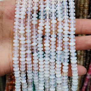 Macro shot of semi-translucent 4x6mm rondelle beads with blue iridescent sheen for DIY