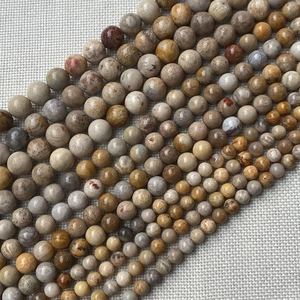 Natural round stone beads in earthy tones for DIY jewelry making and crafting projects
