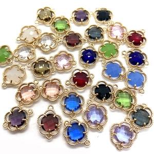 Flower-shaped faceted crystal connectors in various colors with golden double loops