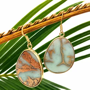 Detailed close-up of retro water-drop tiger eye stone earrings with golden metal edges