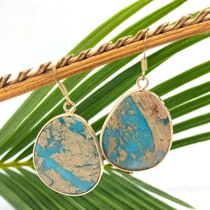 Natural tiger eye stone teardrop earrings with gold plating on organic wood branch