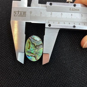 Measuring a 14mm natural oval abalone shell bead with a digital caliper tool