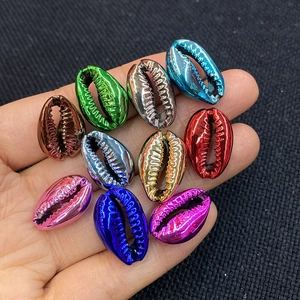 Macro view of metallic electroplated natural cowrie shells in ten vibrant assorted colors