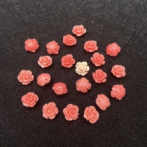 Detailed macro view of pink synthetic coral rose beads for DIY jewelry making