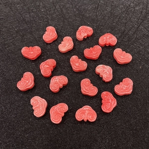 Close-up of red synthetic coral beads in cloud shape for DIY jewelry making