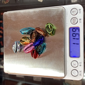 Close-up of colorful metallic electroplated sea shell beads for DIY jewelry making
