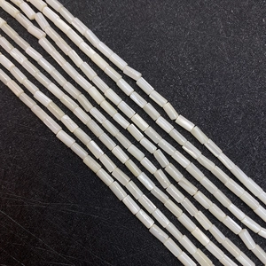 Macro detail of cylindrical natural mother of pearl beads for DIY jewelry making