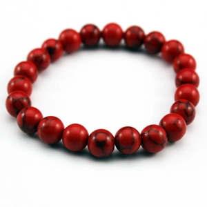 Macro detail of red turquoise stone beads bracelet with distinct black marble texture