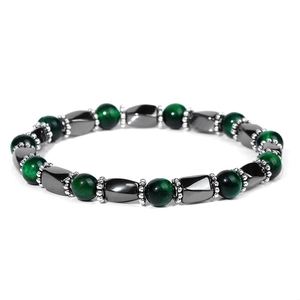Detailed macro of green tiger eye beads and hematite geometric stones on elastic bracelet
