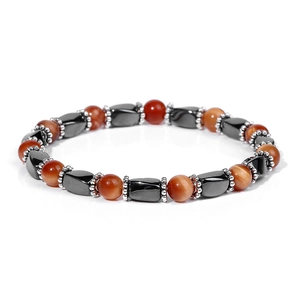 Macro detail of natural tiger eye beads and hematite stones on an elastic bracelet