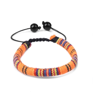 Detail of bohemian hand-woven cotton bracelet with adjustable knot and colorful textures