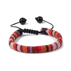 Close-up of woven bohemian bracelet detail featuring adjustable black cords and beads