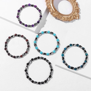 Detailed display of five colorful stone beaded bracelets on white geometric pedestals