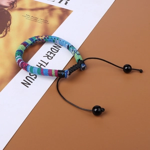 Handmade Bohemian braided bracelet with colorful fabric ropes and adjustable cords