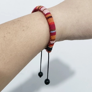 Bohemian woven friendship bracelet with colorful fabric cords and adjustable pull string