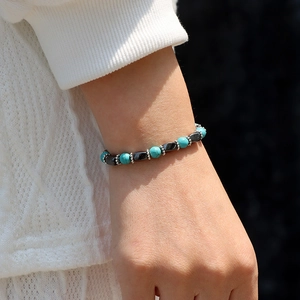 Beaded bracelet with turquoise and black magnetic stones on a male wrist model