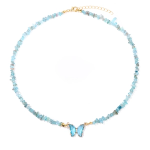 Detail of light blue gemstone bead necklace with a transparent butterfly pendant and gold clasp