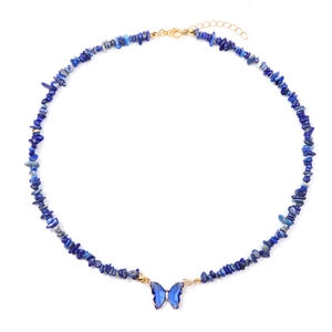 Macro detail of blue stone bead necklace with translucent butterfly pendant and gold clasp