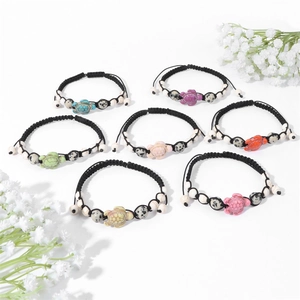 Detail of 7-piece adjustable turtle bracelets with colorful stone beads and black wax cord