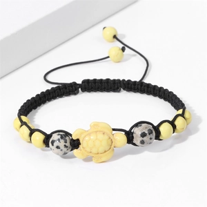 Detail of handmade braided rope bracelet with turtle charm and natural stone beads