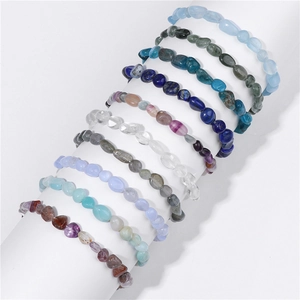Set of 10 natural irregular gemstone stretch bracelets on a white display stand