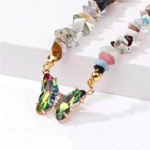 Detailed shot of a colorful gradient butterfly pendant with crushed stone bead chain