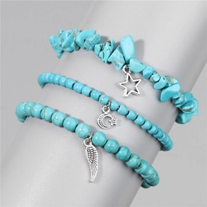 Detail of turquoise beaded bracelet set featuring silver star and feather charms