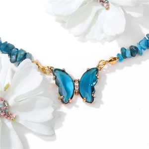 Minimalist blue stone beaded necklace with a butterfly pendant and golden accents