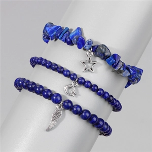 Detail of blue lapis stone beaded bracelets featuring star and feather charms
