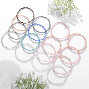 Detail of colorful faceted crystal beaded elastic bracelets set with floral accents