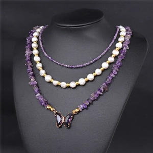 Three-layer retro necklace featuring purple stones, pearls, and a butterfly pendant