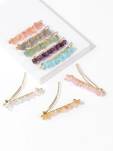 Detailed close-up of natural stone hair clips with various crushed gemstones on gold plating