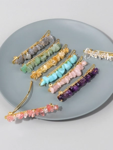 Macro shot of natural crystal stone hair clips in various colors on golden metal base